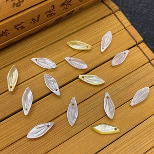 Macro view of natural diamond-shaped seashell pendants with a lustrous pearly finish