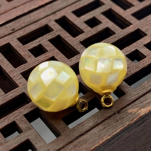 Macro view of 8-12mm yellow iridescent seawater shell mosaic sphere pendant charms