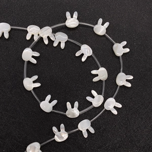 Spiral arrangement of rabbit-shaped natural shell beads for DIY jewelry making