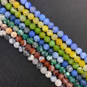 Macro detail of multi-colored dragon vein agate round beads with natural crackle texture