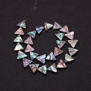 Macro detail of iridescent triangular abalone shell beads for DIY jewelry making