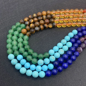 Macro shot of 6-8mm mixed natural stone beads including tiger eye and turquoise for DIY