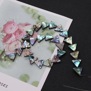 Macro view of triangular iridescent abalone shell beads for DIY jewelry making
