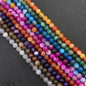 Macro detail of mixed color striped agate beads showing natural veins and polished surface