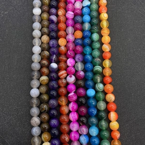 Detailed view of colorful striped agate beads in diverse vibrant patterns and textures