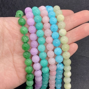 Macro shot of colorful 6-10mm natural stone beads in purple and green for DIY jewelry