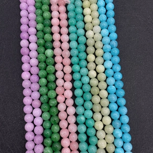 Close-up of polished 6-10mm natural stone beads in various colors for DIY jewelry making