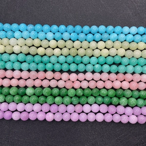 Detailed macro view of 6-10mm polished natural stone beads in six vibrant colors
