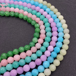 Close-up of polished 8-10mm round natural stone beads in six vibrant colors for DIY jewelry
