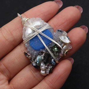Handmade freshwater pearl pendant with blue resin stone and silver wire wrap detail
