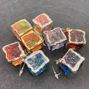 Macro detail of mixed natural stone cube pendants with electroplated metal edges for DIY jewelry