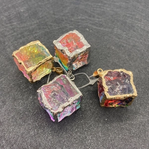 Detailed close-up of mixed natural stone crystal cube pendants with metal loop bail