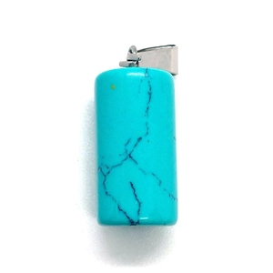Macro shot of turquoise stone cylinder pendant with unique black veins and silver bail