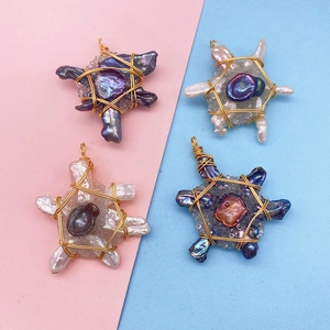 Macro detail of handmade wire wrapped baroque pearl and crystal cluster pendants