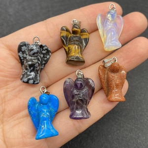 Set of six natural stone angel pendants in hand showing various semi-precious gem materials
