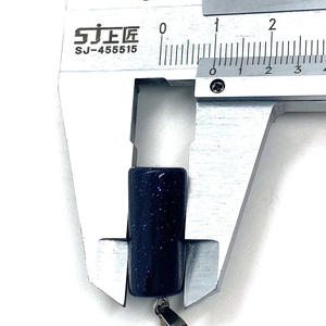 Macro shot showing 10mm width measurement of Blue Goldstone cylinder pendant
