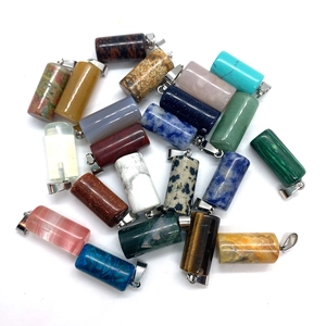 Various cylindrical gemstone pendants with silver clasps on a clean white background