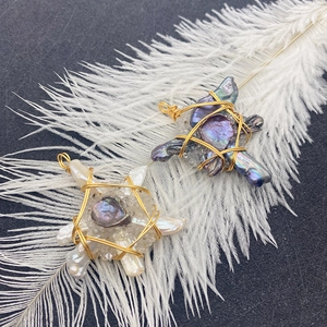 Handmade star-shaped baroque pearl pendants with gold wire wrapping on white feather