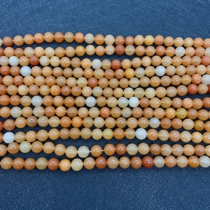 Macro detail of polished 6-10mm natural orange aventurine stone beads for jewelry