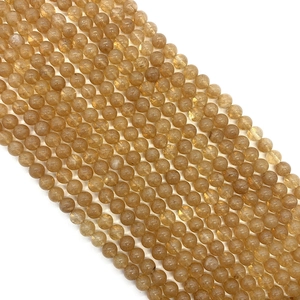 Golden strawberry quartz round beads for DIY jewelry making in a diagonal layout