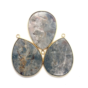 Three teardrop amazonite stones with gold metal frames and hanging loops on white background