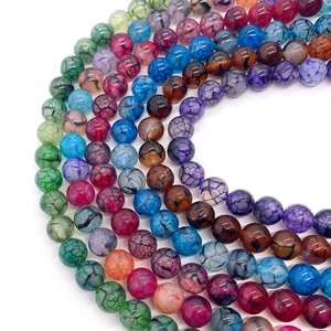 Macro detail of colorful dragon vein agate round beads showing unique crackle textures