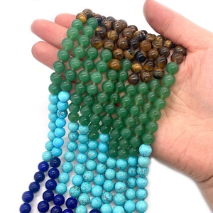 Macro view of various natural tiger eye and turquoise round beads for DIY jewelry making