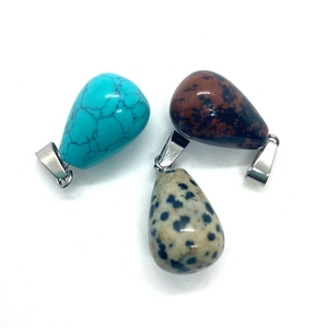 Three teardrop-shaped natural stone pendants with polished silver clasps in various textures