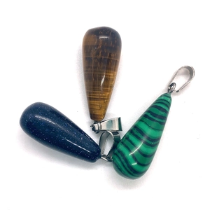 Polished teardrop stone pendants set with tiger eye, blue sand, and malachite textures