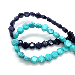 Macro shot of 8mm hexagonal cut blue goldstone and turquoise beads for DIY jewelry