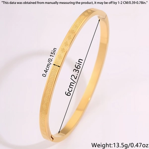 Detail view of gold titanium steel bangle with Greek key pattern and size measurements