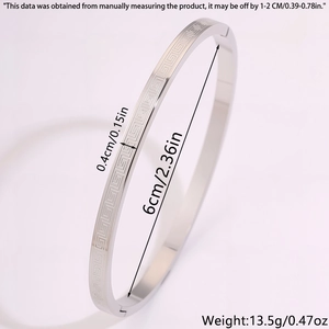 Detail view of silver titanium steel bangle with Greek meander pattern and dimensions