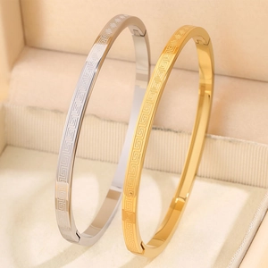 Polished titanium steel bracelets with Greek meander pattern in gold and silver finish