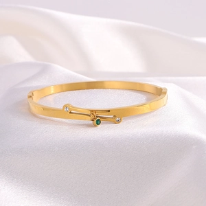 Titanium steel crossover gold bracelet featuring emerald pendant and diamond accents