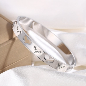 Detailed macro view of silver stainless steel heart bracelet with shimmering crystals