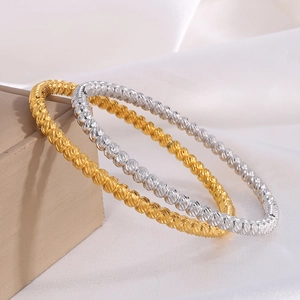 Sparkling diamond cut stainless steel bangles in gold and silver set on silk