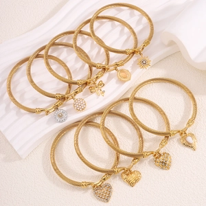 Gold stainless steel twisted cable bracelet set with heart flower and bow charms