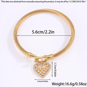 Detailed view of golden twisted cable bracelet with crystal heart charm and dimensions