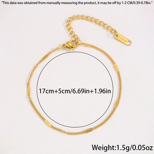 Detail view of gold Figaro stainless steel bracelet with flat sequins and lobster clasp