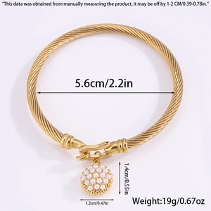 Close-up of golden twist bangle with horseshoe faux pearl pendant and dimensions