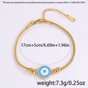 Detailed view of gold snake chain with evil eye charm, lobster clasp and extension
