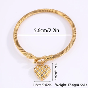Detail shot of gold braided bangle with heart pendant showing 5.6cm inner diameter size