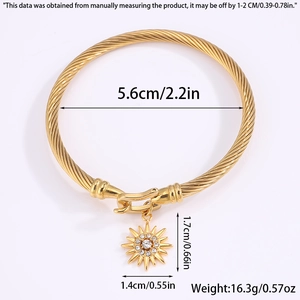 Detailed view of gold spiral cuff bracelet with rhinestone floral pendant and dimensions