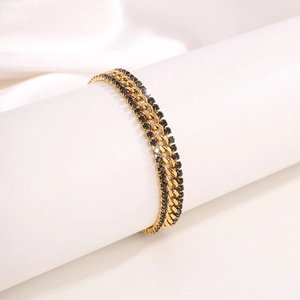 Close-up of triple-layered 18k gold plated stainless steel bracelet with black crystals