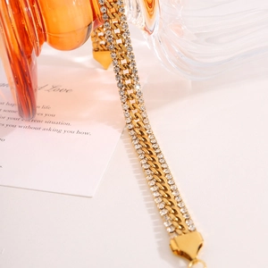 Detail of 18k gold plated stainless steel Cuban chain bracelet with pavé rhinestones