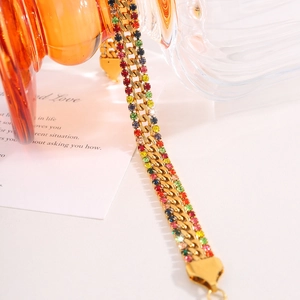 Detail of gold Cuban chain bracelet featuring colorful pavé crystals and sturdy clasp
