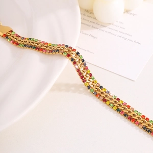 Macro shot of 18k gold plated stainless steel Cuban chain with colorful rhinestones