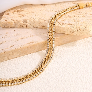 Macro shot of gold double-row rhinestone Cuban chain bracelet with polished finish