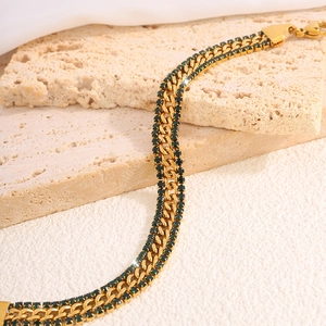 Detail of 18k gold plated stainless steel Cuban chain with green zircon stones inlay