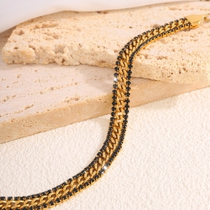 Detail of 18k gold plated stainless steel Cuban chain with double row black zircons